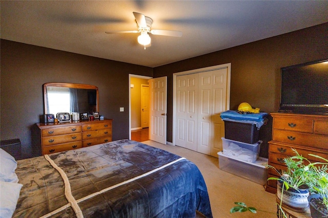 carpeted bedroom featuring a closet and a ceiling fan