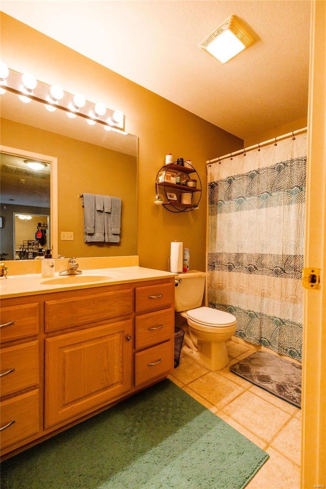 bathroom with visible vents, a shower with curtain, toilet, tile patterned flooring, and vanity