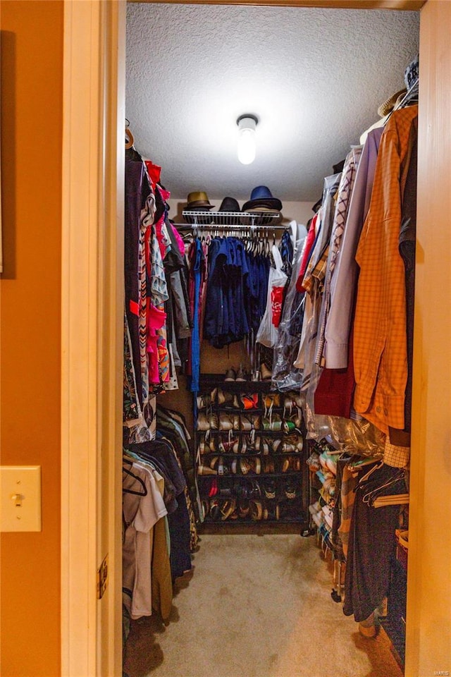 walk in closet with carpet floors