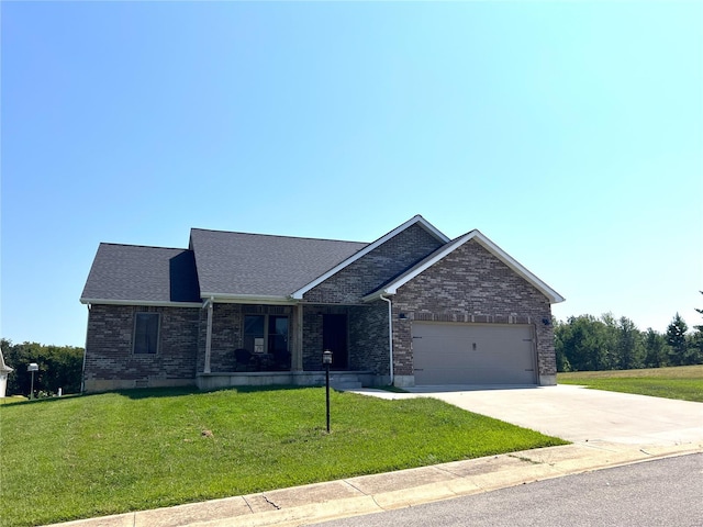 view of front of property with a garage and a front yard