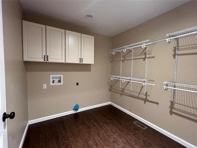 laundry room featuring hookup for an electric dryer, dark wood-type flooring, washer hookup, and cabinets