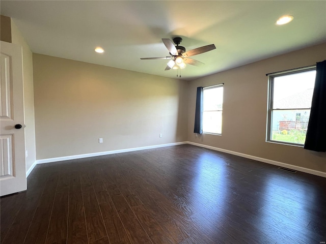 unfurnished room with dark hardwood / wood-style flooring and ceiling fan