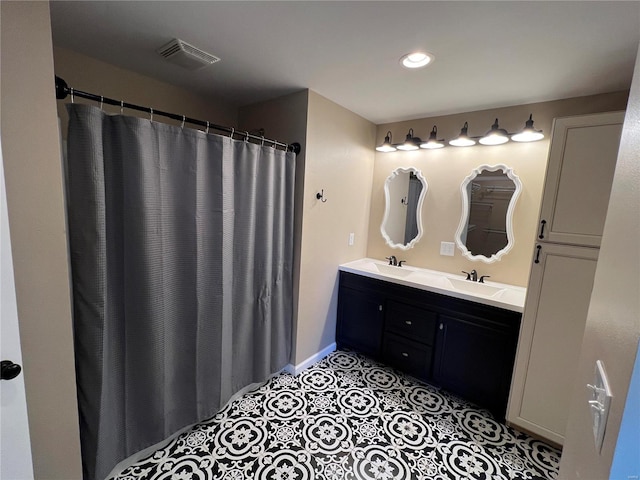 bathroom featuring tile patterned flooring and vanity