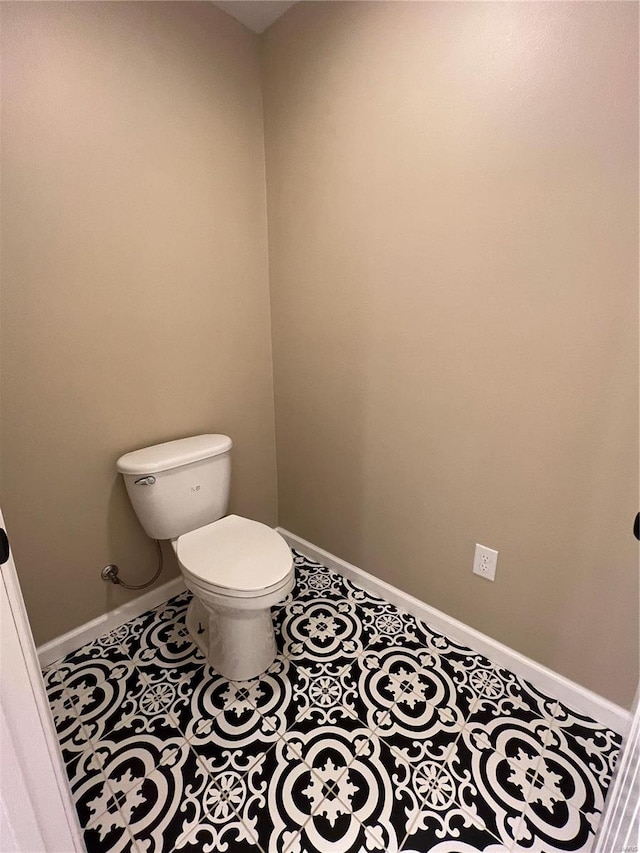 bathroom with toilet and tile patterned floors