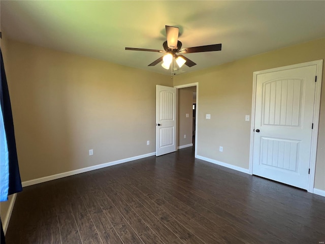 unfurnished bedroom featuring ceiling fan and dark wood-type flooring