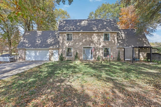 view of front of property featuring a front lawn and a garage