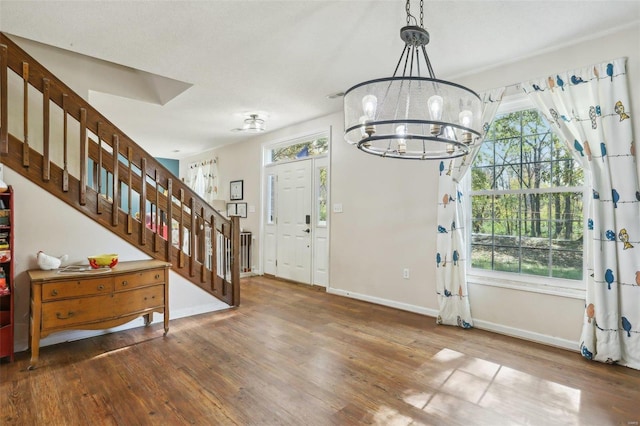 entrance foyer featuring a chandelier and dark hardwood / wood-style floors