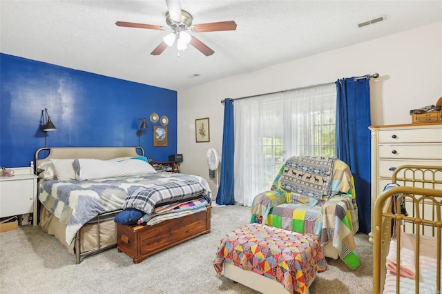 bedroom featuring a textured ceiling, carpet flooring, and ceiling fan