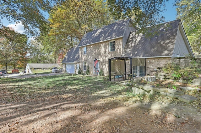 rear view of property with a garage