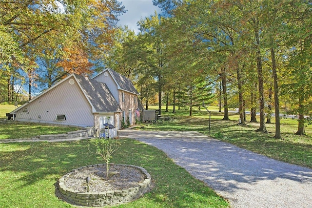 view of property exterior featuring a lawn