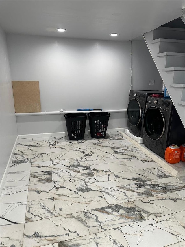 laundry room featuring washer and clothes dryer and tile patterned floors