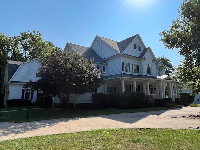 view of front of house with covered porch and a front yard