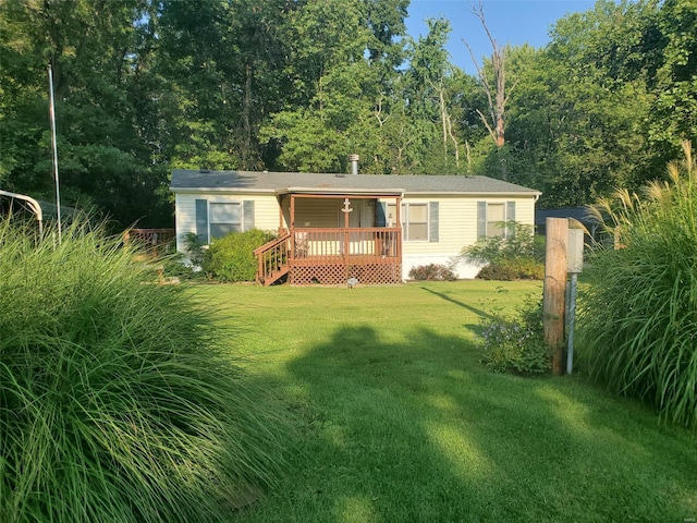 view of front of home featuring a front lawn and a wooden deck