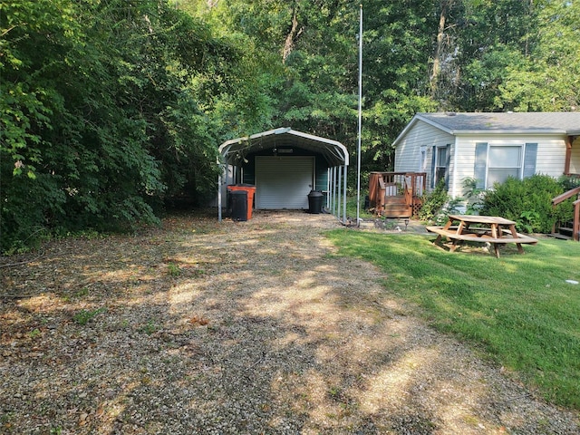 view of yard featuring a wooden deck and a carport