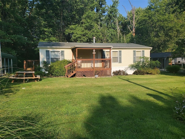 view of front of property featuring a deck and a front lawn