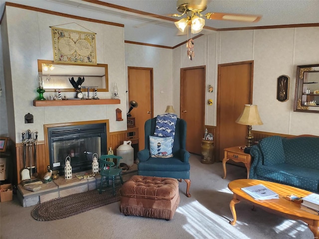 carpeted living room featuring crown molding, a textured ceiling, ceiling fan, and a tile fireplace