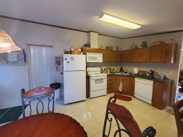 kitchen with a textured ceiling, ornamental molding, light tile patterned floors, and white appliances