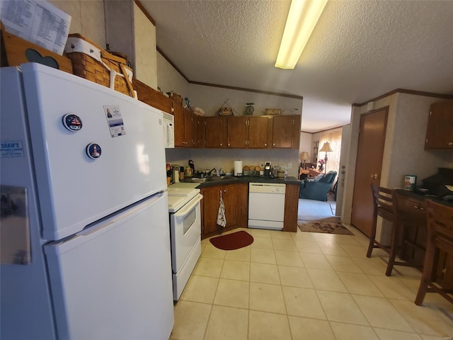 kitchen with a textured ceiling, crown molding, sink, and white appliances