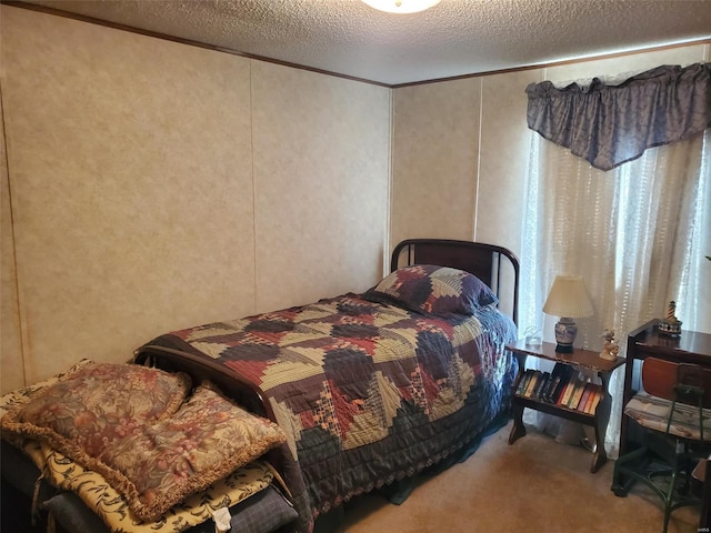 bedroom featuring a textured ceiling and carpet flooring