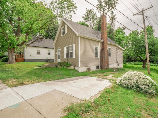 view of side of home featuring a lawn