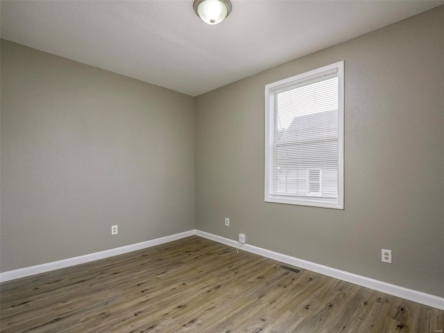 unfurnished room featuring hardwood / wood-style flooring