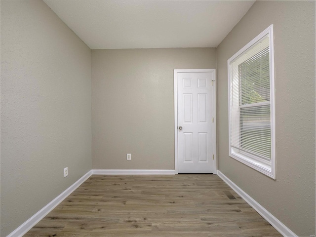 unfurnished room with a wealth of natural light and light hardwood / wood-style floors