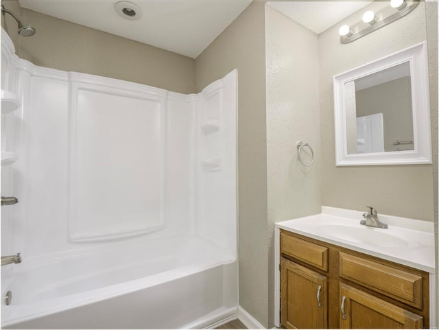 bathroom featuring shower / tub combination and vanity