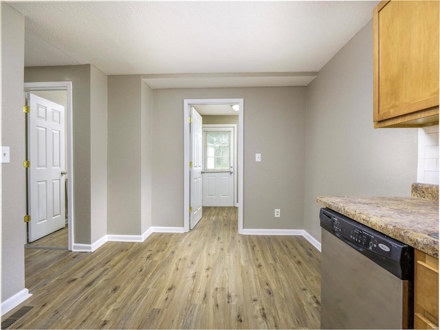 kitchen with light wood-type flooring, a textured ceiling, and stainless steel dishwasher