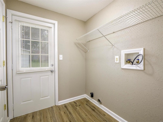 laundry room with hookup for a washing machine and hardwood / wood-style flooring