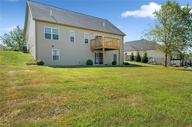 rear view of property with a lawn and cooling unit