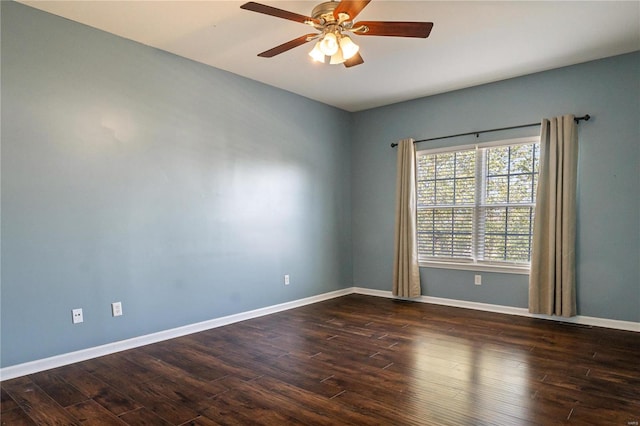 spare room featuring dark wood-type flooring and ceiling fan