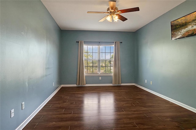 spare room featuring dark wood-type flooring and ceiling fan