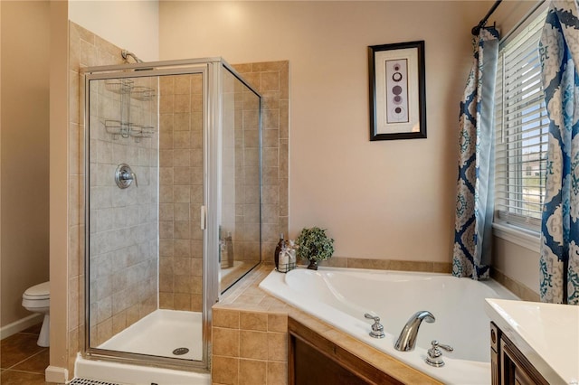 full bathroom featuring vanity, shower with separate bathtub, toilet, and tile patterned flooring