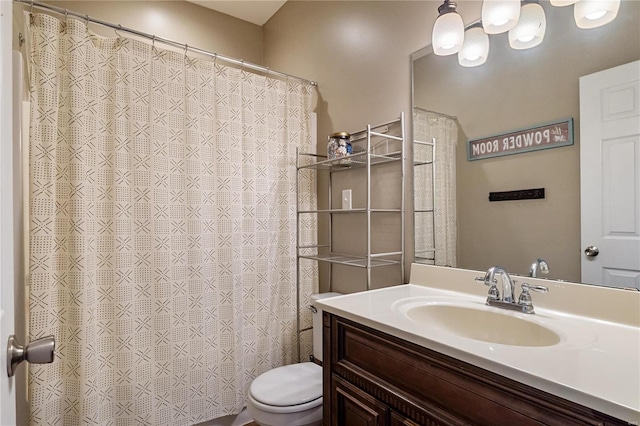 bathroom with vanity, a shower with shower curtain, and toilet