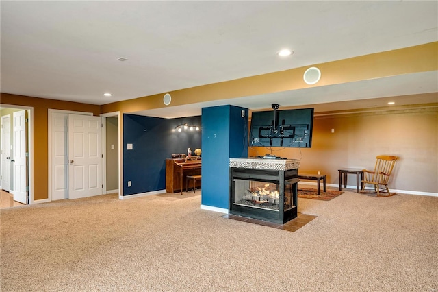 living room featuring a multi sided fireplace and carpet floors