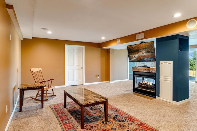 living room featuring carpet and a multi sided fireplace