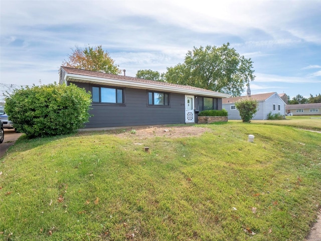 single story home featuring a front lawn