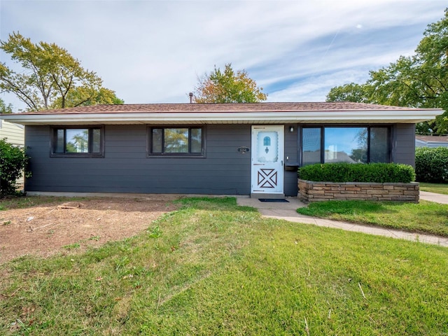 ranch-style house featuring a front lawn