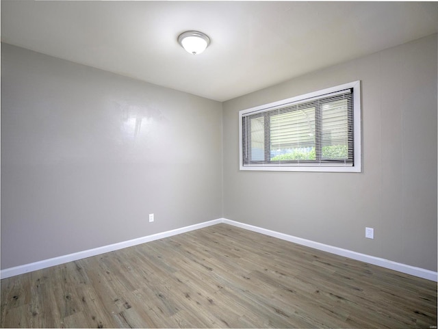 empty room with hardwood / wood-style floors