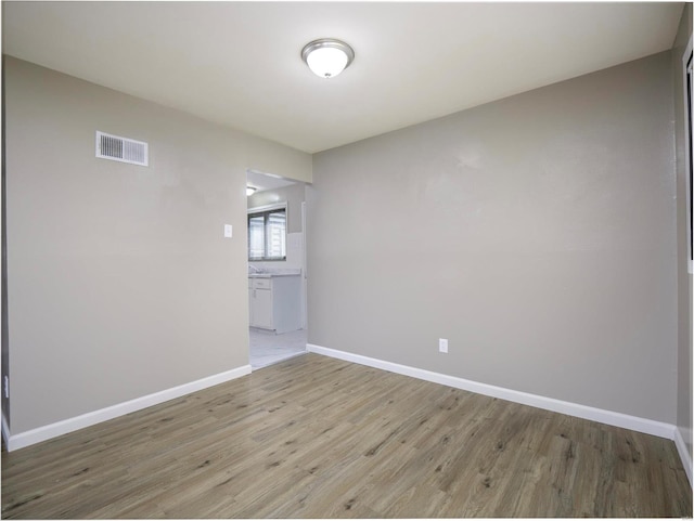 unfurnished room featuring light hardwood / wood-style flooring