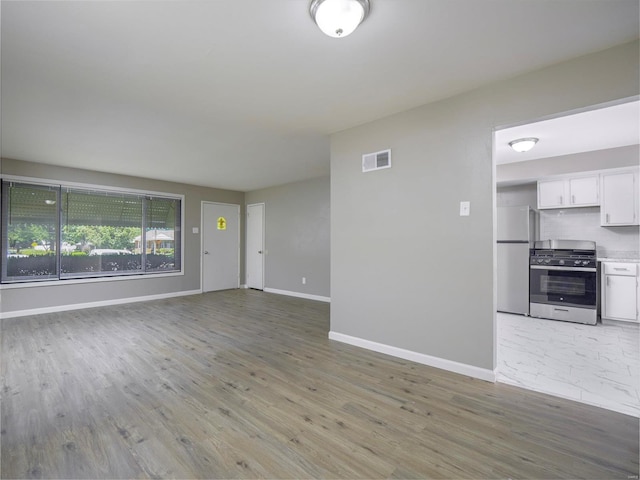 unfurnished living room featuring hardwood / wood-style floors