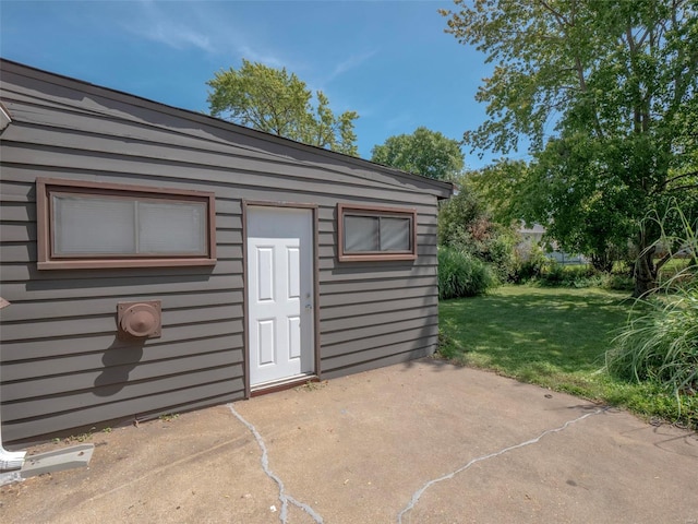 view of outbuilding featuring a lawn