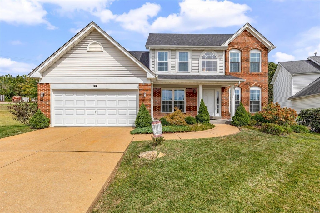 view of front facade featuring a garage and a front lawn