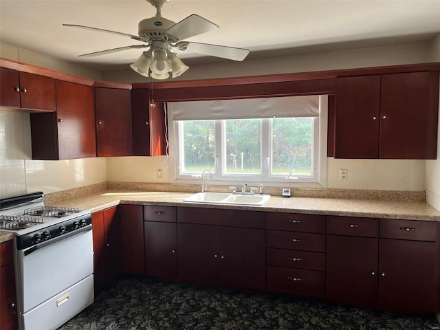 kitchen with gas range gas stove, ceiling fan, and sink