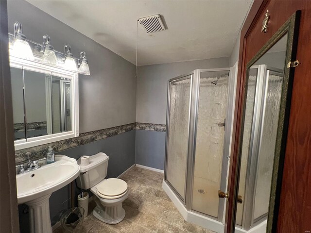 bathroom with walk in shower and toilet