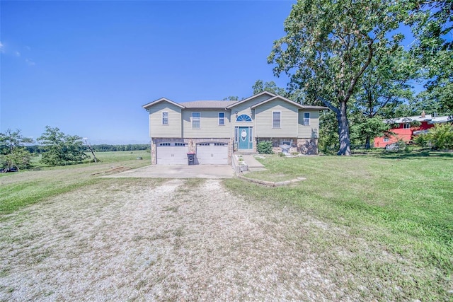 back of house featuring a lawn and a garage