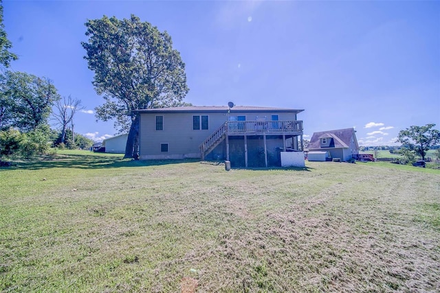 back of property featuring a yard and a wooden deck