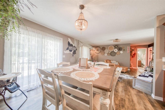 dining space featuring a chandelier and hardwood / wood-style flooring