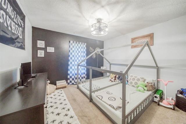 bedroom featuring carpet flooring and a textured ceiling