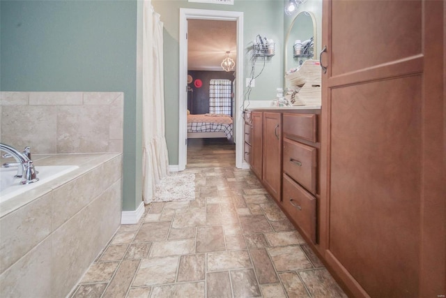 bathroom featuring vanity and a washtub